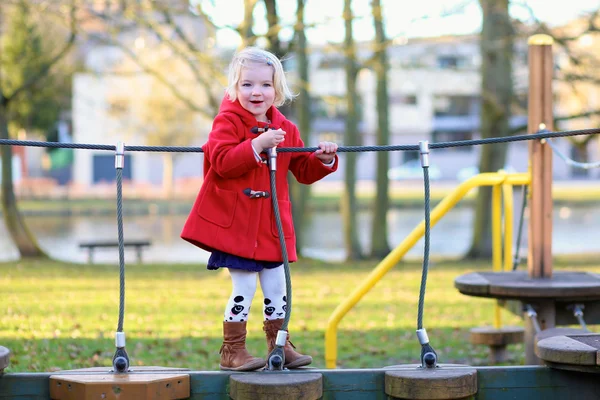 Preschooler girl having fun at playground