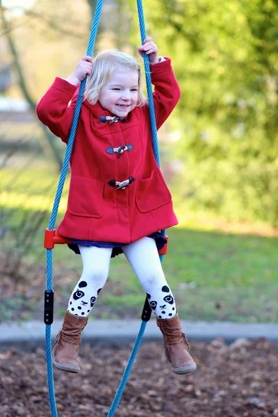 Preschooler girl having fun at playground