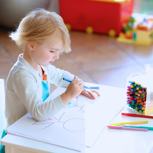 Lovely little girl drawing with felt-tip pens
