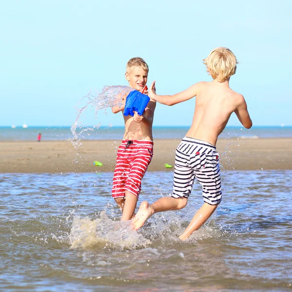Two active boys playing on the beach