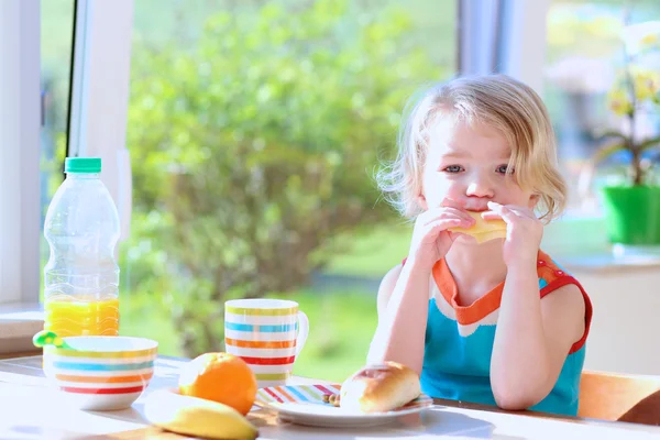 Adorable little kid enjoying breakfast