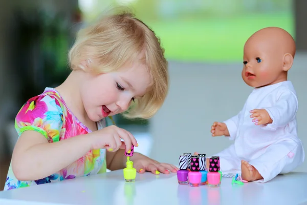 Little girl applying nail polish