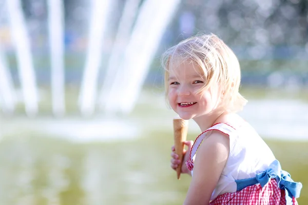 Cute little girl eating ice cream on summer day