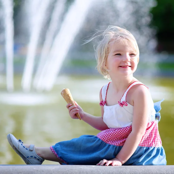 Cute little girl eating ice cream on summer day
