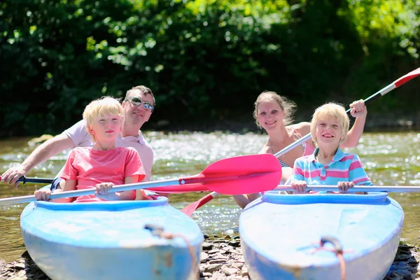 Happy family kayaking on the river