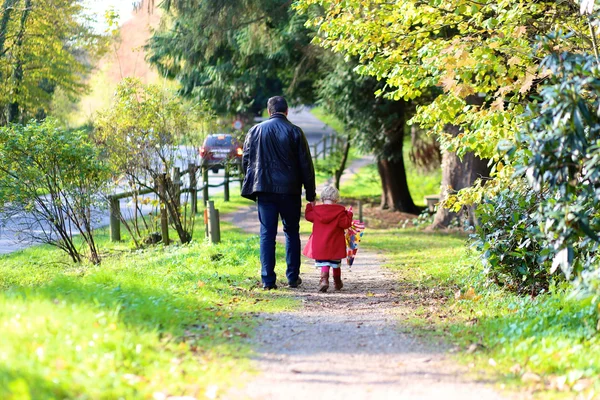 Father and daughter walking in the park