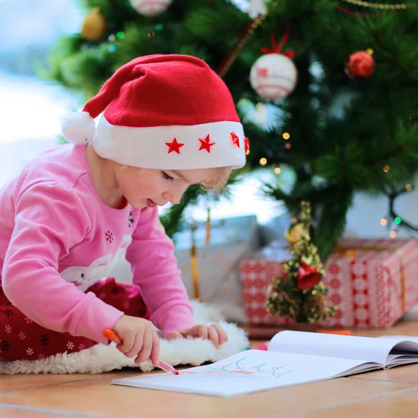 Lovely little girl writing letter to Santa