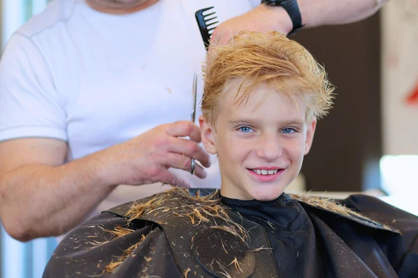 Cute teenage boy at hairdress