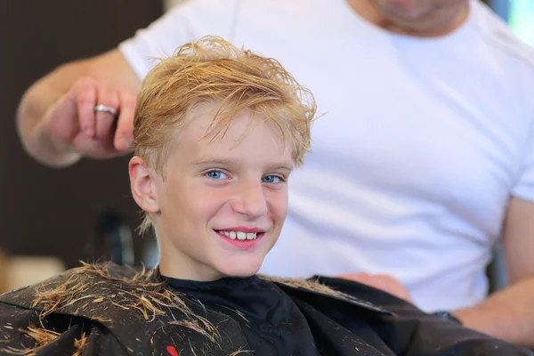 Cute teenage boy at hairdress