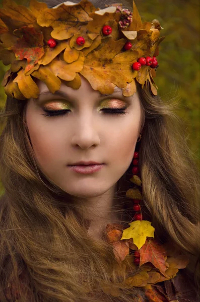 Autumn forest witch, woman in fall way, dress from the leaves