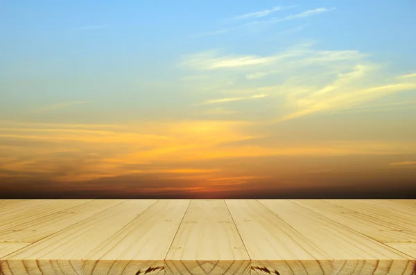 Picnic wood table and Blurred Sunrise Background.