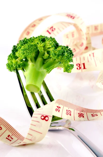 Broccoli, Tape Measure, Fork and Spoon in Waistline and Weight Control Concept by Diet Control.