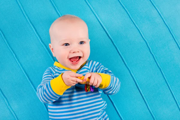 Baby boy on blue knitted blanket