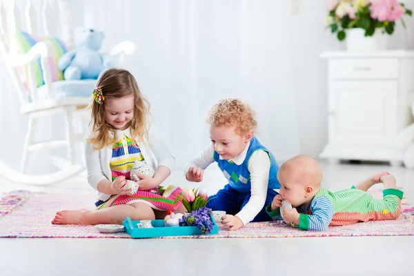 Children playing toy tea party