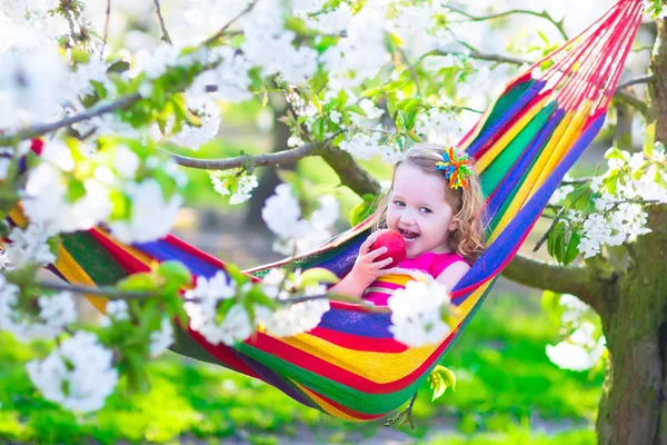 Little girl relaxing in a hammock