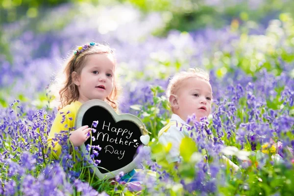 Kids with flowers and chalk board