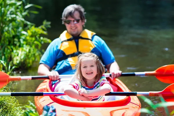 Father and child kayaking in summer