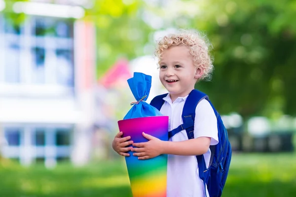 Little child with candy cone on first school day