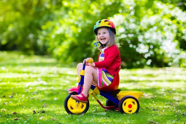 Little girl riding a tricycle