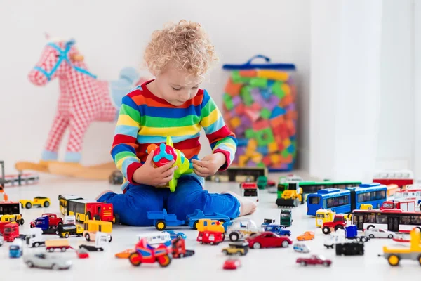 Little boy playing with toy cars