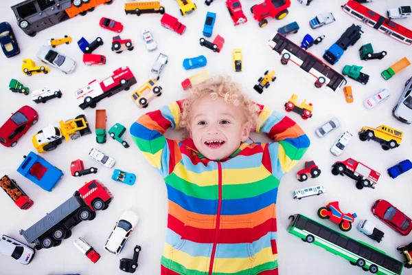 Little boy playing with toy cars