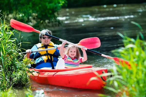 Father and child kayaking in summer