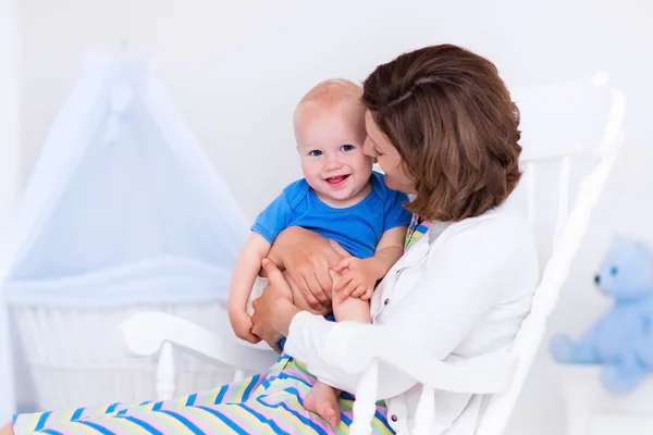 Mother and baby in white bedroom