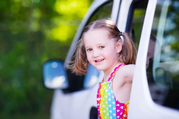 Little girl sitting in white car