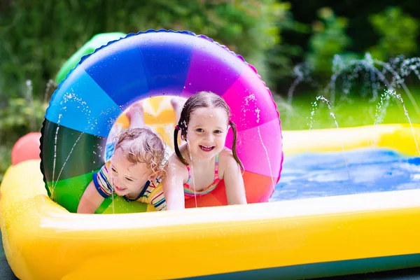 Kids playing in garden swimming pool