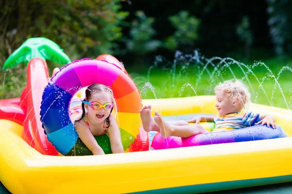 Kids playing in garden swimming pool