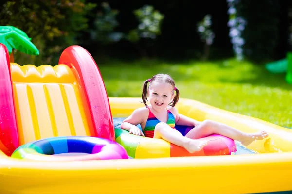 Little girl in garden swimming pool