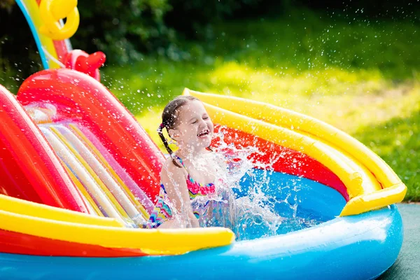 Little girl in garden swimming pool