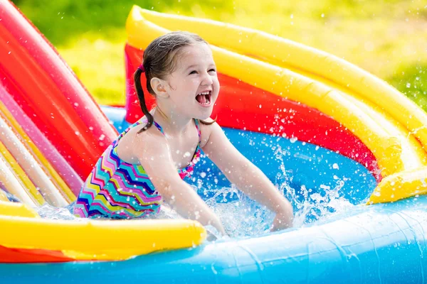 Little girl in garden swimming pool