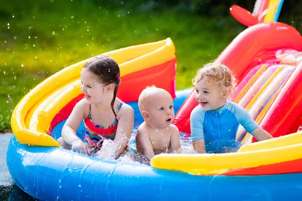 Kids playing in inflatable swimming pool