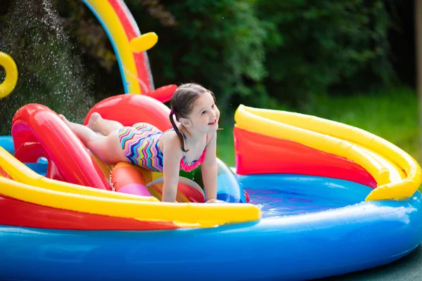 Little girl in garden swimming pool