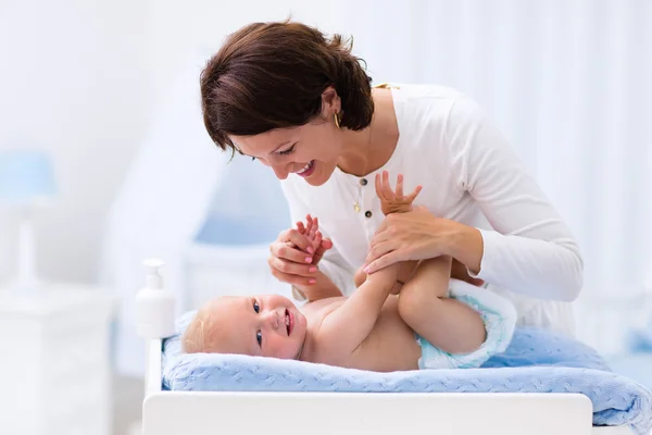 Mother and baby on changing table