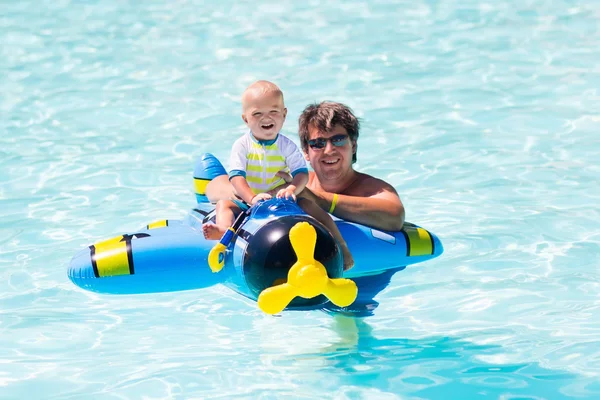Father and baby in swimming pool
