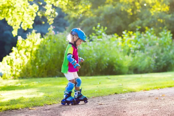 Kids roller skating in summer park