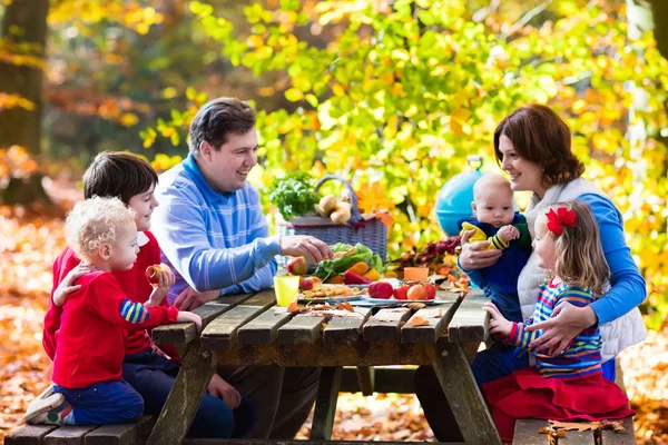 Family having picnic in autumn