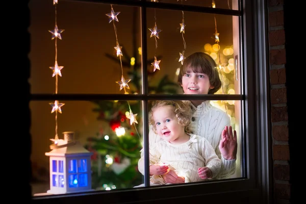 Kids at window on Christmas eve
