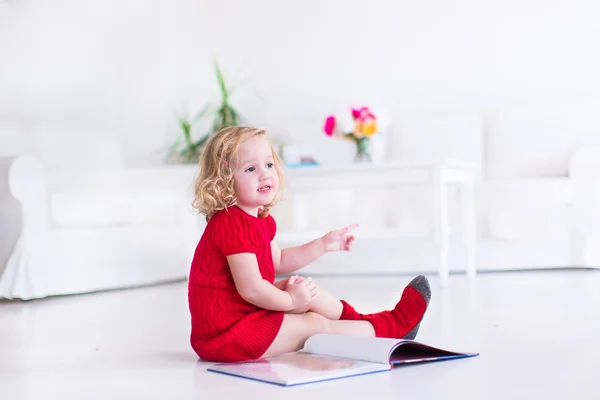 Little girl reading a book