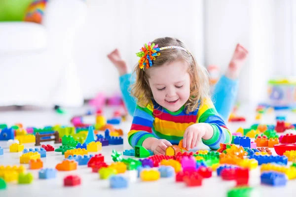 Little girl playing with toy blocks