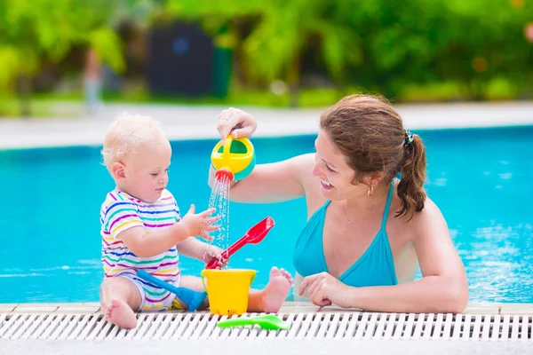 Mother and baby playing in swimming pool