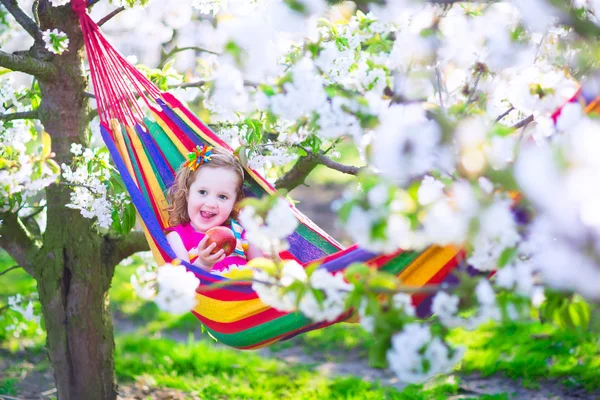 Little girl relaxing in a hammock