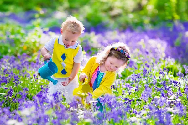 Kids In A Garden With Bluebell Flowers