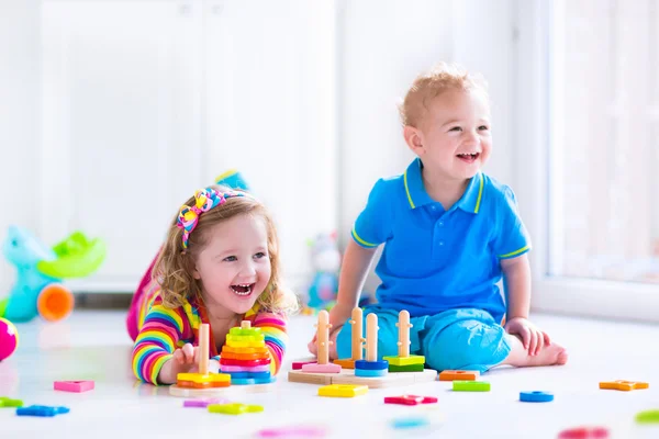 Cjildren playing with wooden toys