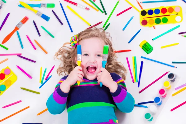 Littel girl with school art supplies