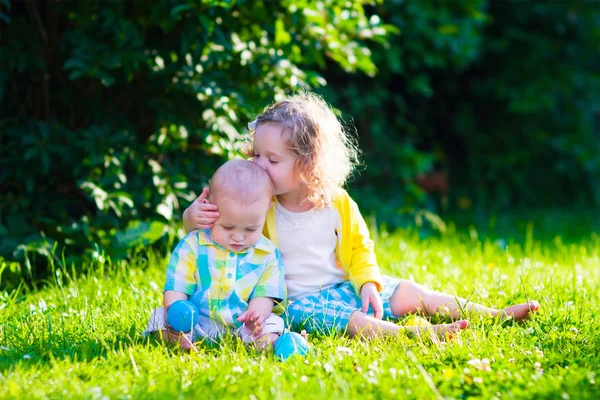 Happy children playing in the garden with toy balls