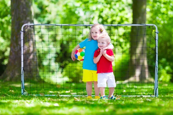 Children playing football outdoors