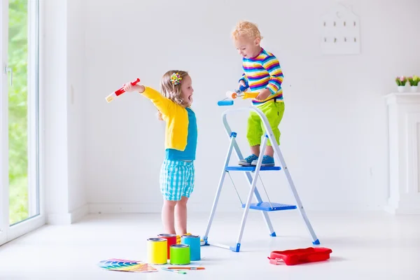 Children painting walls at home